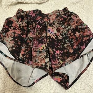 Size 2 lululemon hotty hot shorts 4”. They are some kind of a floral pattern.